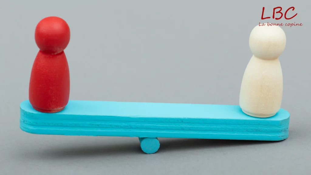 Two wooden pawns, red and white, placed at opposite ends of a blue board, symbolizing a fragile balance