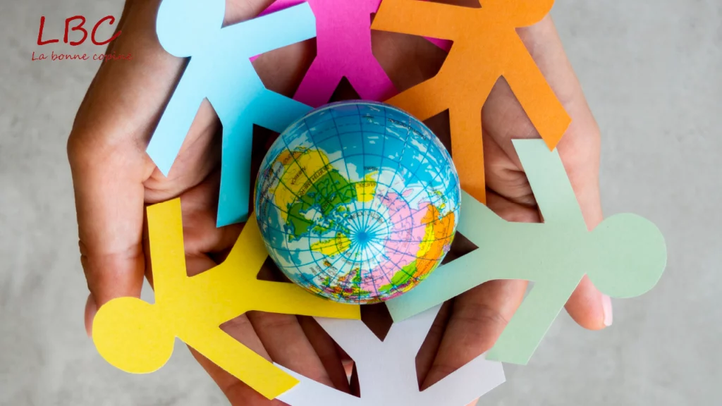 Hands form a protective circle around a globe, while colorful human figures surround it, symbolizing the unity, diversity and protection of our shared world | labonnecopine.com/en