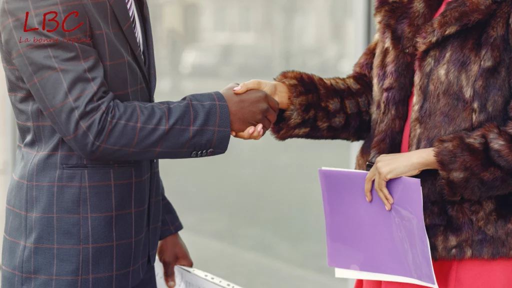 A professional handshake between a sharply dressed man and an elegant woman in a fur coat, symbolizing a confident, stylish meeting