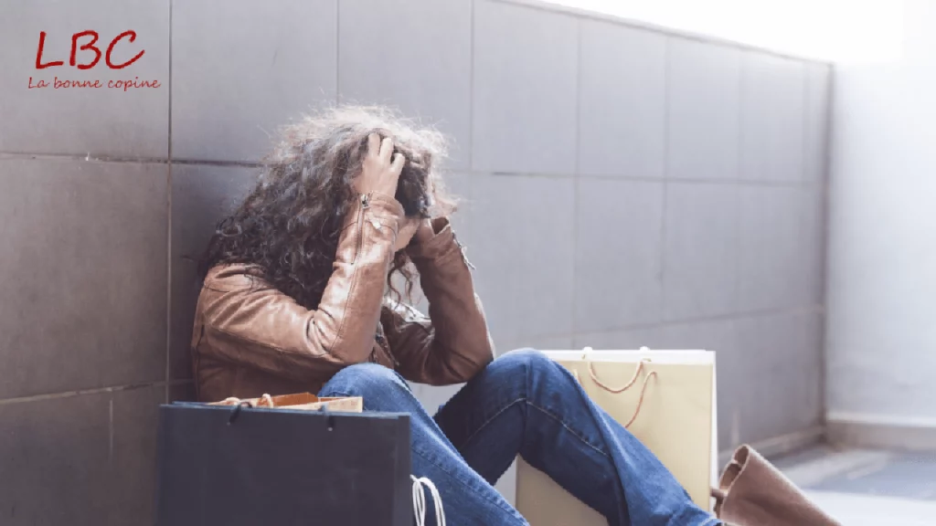A woman sits on the floor, head in hands, surrounded by moving boxes, in a tiled interior. An emotionally-charged scene of fatigue, transition and new beginnings | labonnecopine.com/en
